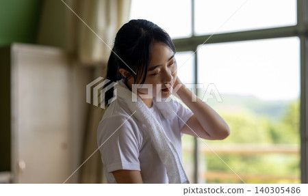 Young woman wiping sweat Young woman wiping sweat 140305486