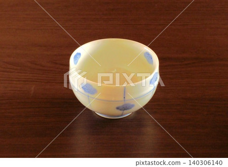 White porcelain teacup with blue accents White porcelain teacup with blue accents 140306140