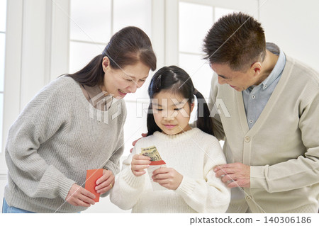 Grandmother and grandfather giving New Year's money to their grandchild Grandmother and grandfather giving New Year's money to their grandchild 140306186