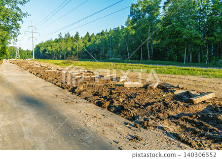 Rural powerline corridor with cleared earth and stacked concrete slabs Rural powerline corridor with cleared earth and stacked concrete slabs 140306552