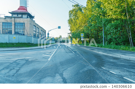 Empty urban road with industrial building and leafy trees at dawn Empty urban road with industrial building and leafy trees at dawn 140306610