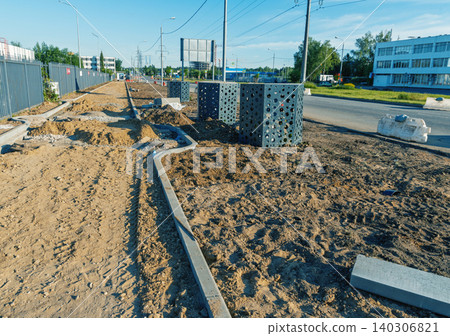 Urban sidewalk construction site with curbstones and drainage boxes Urban sidewalk construction site with curbstones and drainage boxes 140306821
