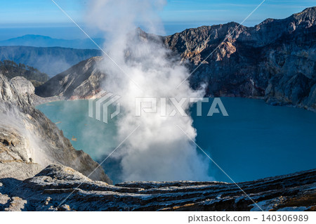 Scenery view of the acid crater lake in Kawah Ijen volcano located in East Java, indonesia. The lake is recognised as the largest highly acidic crater lake in the world. Scenery view of the acid crater lake in Kawah Ijen volcano located in East Java, indonesia. The lake is recognised as the largest highly acidic crater lake in the world. 140306989