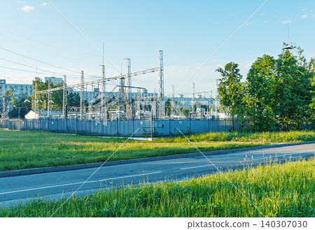 Electrical substation behind grassy roadside with apartment buildings Electrical substation behind grassy roadside with apartment buildings 140307030