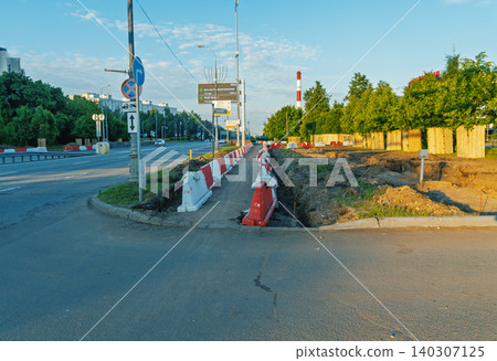 Urban roadside trench and traffic barriers at sunrise 140307125