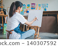 Art student drawing with watercolor painting on canvas doing some art projects on studio workshop 140307592