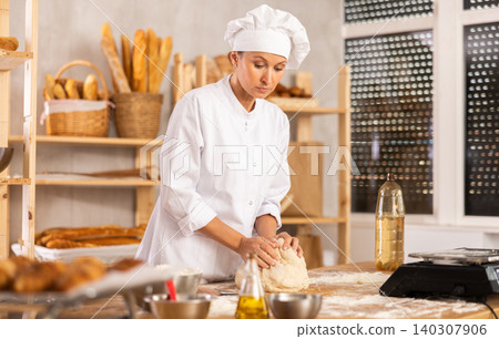 Professional baker kneading dough Professional baker kneading dough 140307906