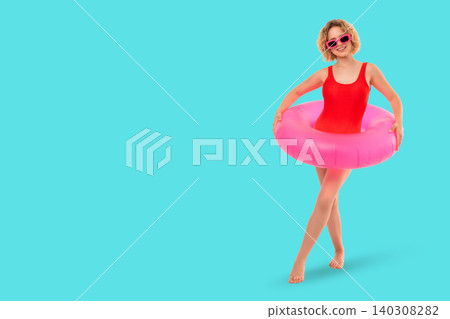 Woman embraces summer fun wearing red swimsuit with pink floaty Woman embraces summer fun wearing red swimsuit with pink floaty 140308282