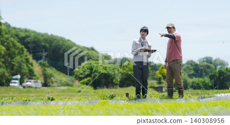 A man using a tablet for farming (banner) 140308956