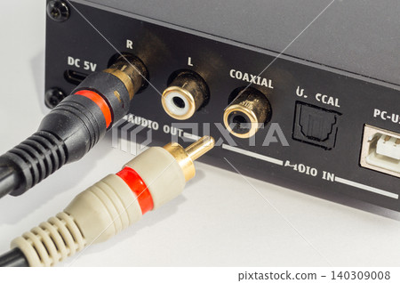 Close-up of RCA connectors plugged into an audio device. Close-up of RCA connectors plugged into an audio device. 140309008