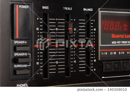 Close-up of volume and tone controls on an audio amplifier. Close-up of volume and tone controls on an audio amplifier. 140309010