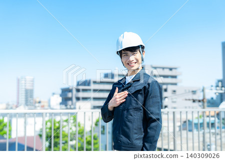 A man in work clothes inspecting equipment. A man in work clothes inspecting equipment. 140309026