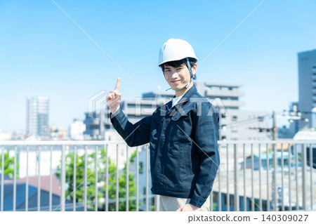 A man in work clothes inspecting equipment. A man in work clothes inspecting equipment. 140309027