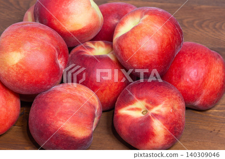 Close-up of ripe peaches on a wooden background 140309046