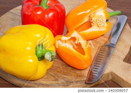 Close-up of a cut sweet pepper on a wooden background. Close-up of a cut sweet pepper on a wooden background. 140309057