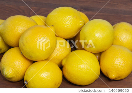 Close-up of many lemons on a wooden background Close-up of many lemons on a wooden background 140309060