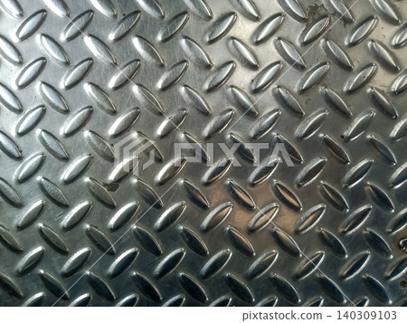 Abstract background a diamond plate, a type of metal sheet characterized by a regular pattern of raised diamonds or lines on one side. Abstract background a diamond plate, a type of metal sheet characterized by a regular pattern of raised diamonds or lines on one side. 140309103