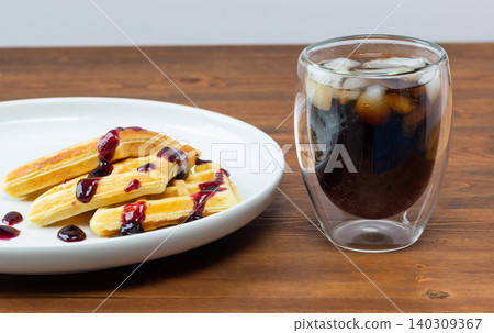 Waffles drizzled with jam. Belgian pastries. Waffles drizzled with jam. Belgian pastries. 140309367