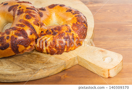 Close-up cheese bagel in wood Close-up cheese bagel in wood 140309370