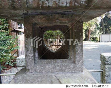Sunlight filtering through the heart-shaped window of a stone lantern Sunlight filtering through the heart-shaped window of a stone lantern 140309434