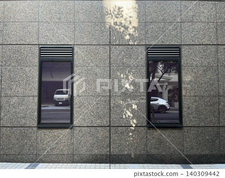 建築物窗戶中映照出的城市景色與街道樹木的陰影形成了鮮明的對比。 140309442