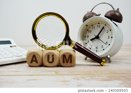 AUM Asset Under Management alphabet letters with magnifying glass, calculator and alarm clock AUM Asset Under Management alphabet letters with magnifying glass, calculator and alarm clock 140309505