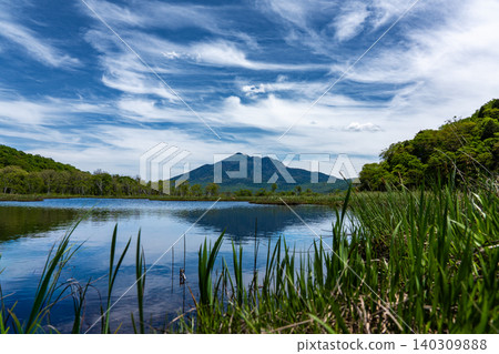 Mount Hiuchigatake reflected in the ponds of Oze Marsh. Mount Hiuchigatake reflected in the ponds of Oze Marsh. 140309888