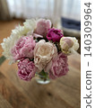 A flower arrangement of pink and white peonies and a warm interior. 140309964