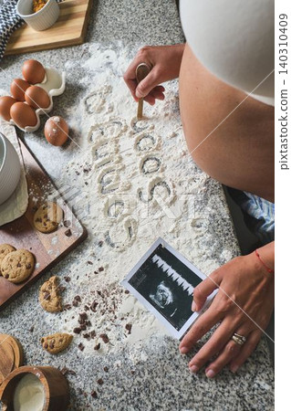 Pregnant woman creating bun in oven with flour and ultrasound Pregnant woman creating bun in oven with flour and ultrasound 140310409