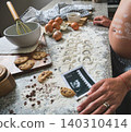 Pregnant woman baking cookies with ultrasound image 140310414