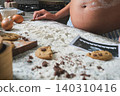 Pregnant woman baking cookies with ultrasound image 140310416