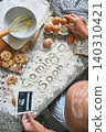 Pregnant woman baking cookies announcing baby coming soon 140310421