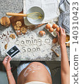 Pregnant woman announcing baby coming soon with baking analogy 140310423