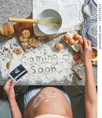 Pregnant woman announcing baby coming soon with baking analogy Pregnant woman announcing baby coming soon with baking analogy 140310423