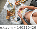 Pregnant woman baking cookies showing baby ultrasound scan 140310426