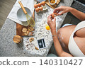 Pregnant woman baking cookies revealing ultrasound baby 140310427