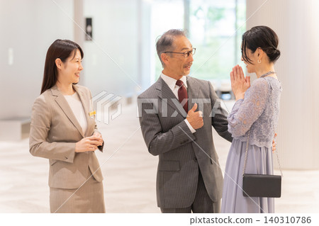 Formal middle-aged couple and staff Formal middle-aged couple and staff 140310786