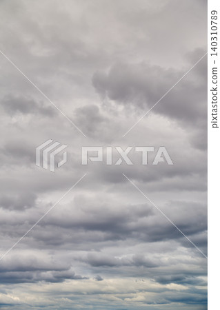 A vast expanse of gray, overcast sky and rain clouds. A variety of cloud formations. A vast expanse of gray, overcast sky and rain clouds. A variety of cloud formations. 140310789