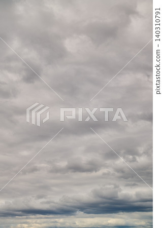 A vast expanse of gray, overcast sky and rain clouds. A variety of cloud formations. A vast expanse of gray, overcast sky and rain clouds. A variety of cloud formations. 140310791