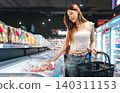 Young adult asian woman consumer choosing food at japanese supermarket store choice buying 140311153