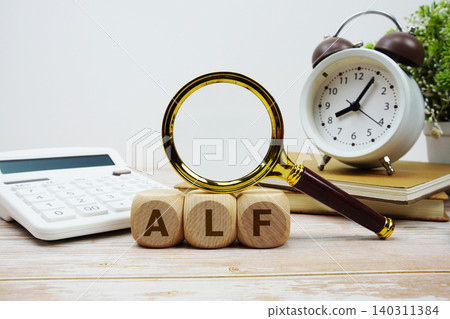 ALF Annual Licensing Fee alphabet letters with magnifying glass, calculator and alarm clock 140311384