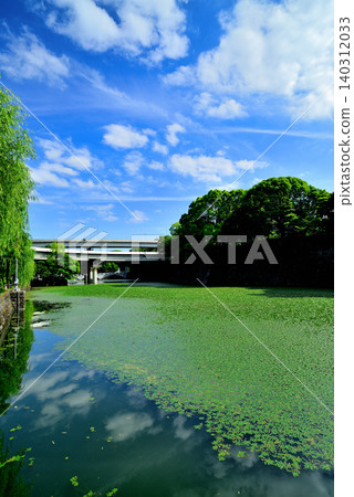 Tokyo: The beautiful Shimizu Moat and the surrounding townscape amidst the fresh greenery. Tokyo: The beautiful Shimizu Moat and the surrounding townscape amidst the fresh greenery. 140312033