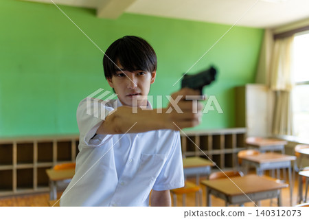 A boy holding a gun in a classroom 140312073