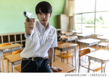 A young man holding a gun A young man holding a gun 140312122