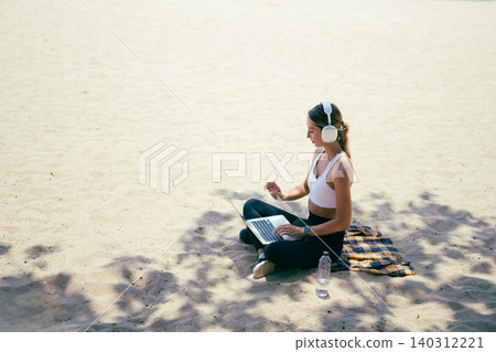 Successful woman balancing work and wellness outdoors under the blue sky 140312221