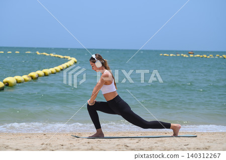 Woman performing yoga lunge on beach with copy space and ocean view Woman performing yoga lunge on beach with copy space and ocean view 140312267