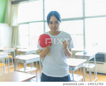 A challenging woman holding a table tennis racket A challenging woman holding a table tennis racket 140312763