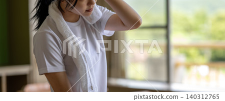 Young woman wiping sweat Young woman wiping sweat 140312765