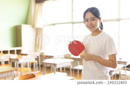A woman holding a table tennis racket A woman holding a table tennis racket 140312803