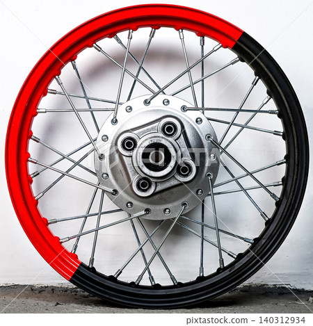 Bicolor red and black motorcycle wheel rim rear view with silver spoke and hub isolated on white background for motorbike custom tuning and repair 140312934